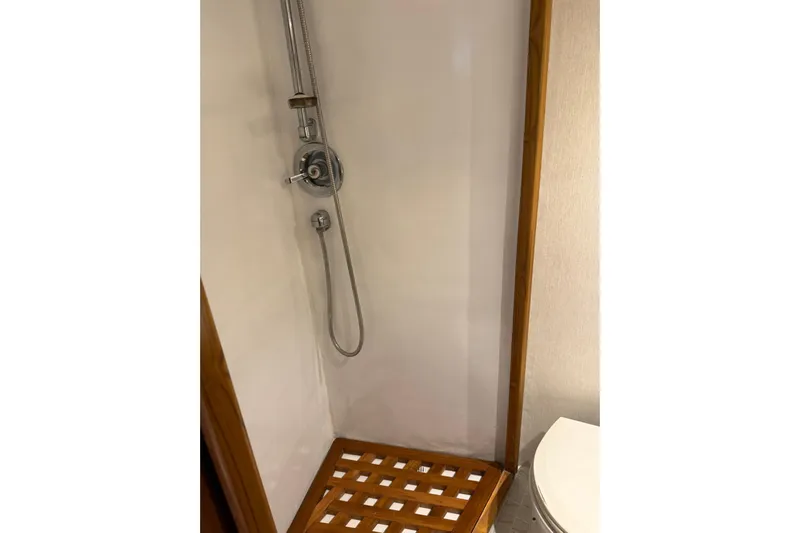  Yacht Photos Pics Shower area in 1989 Buddy Davis 61 yacht with wooden floor and chrome fixtures.