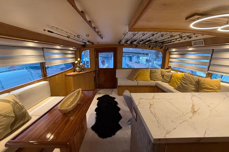  Yacht Photos Pics Luxurious interior of a 1989 Buddy Davis 61 yacht with elegant seating and fishing rods.
