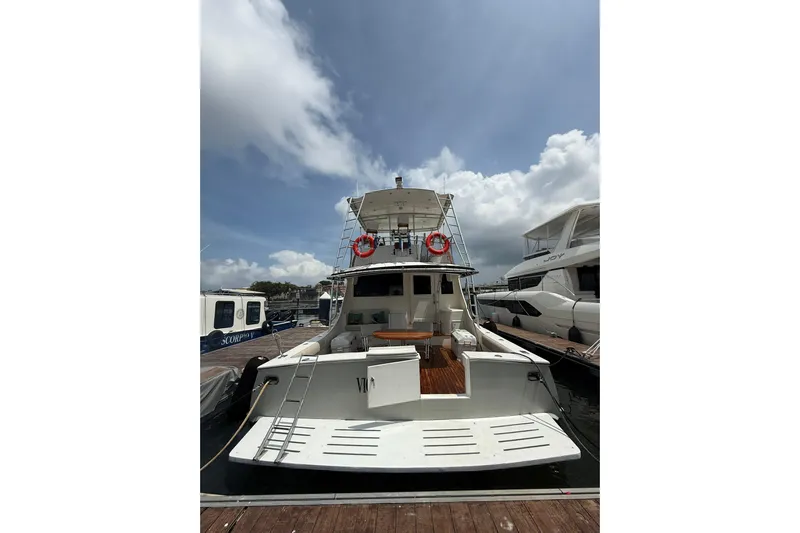  Yacht Photos Pics 1989 Buddy Davis 61 yacht docked at marina under cloudy sky.