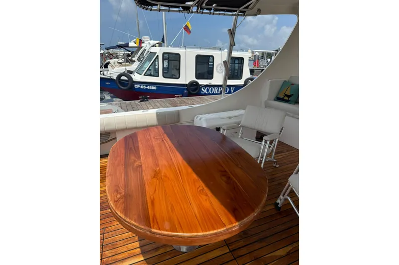  Yacht Photos Pics Luxurious 1989 Buddy Davis 61 yacht interior with wooden table and seating.