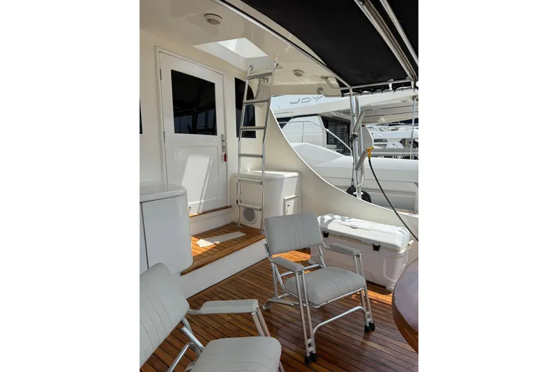  Yacht Photos Pics 1989 Buddy Davis 61 yacht deck with seating, ladder, and wooden flooring.