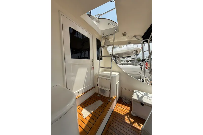 Yacht Photos Pics Interior view of 1989 Buddy Davis 61 yacht with wooden flooring and ladder.