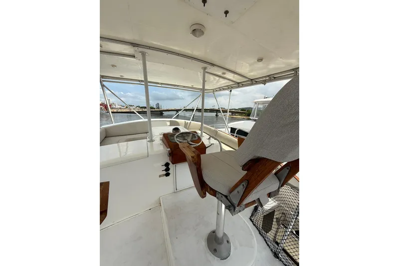  Yacht Photos Pics Helm of 1989 Buddy Davis 61 yacht with steering wheel and captain's chair.