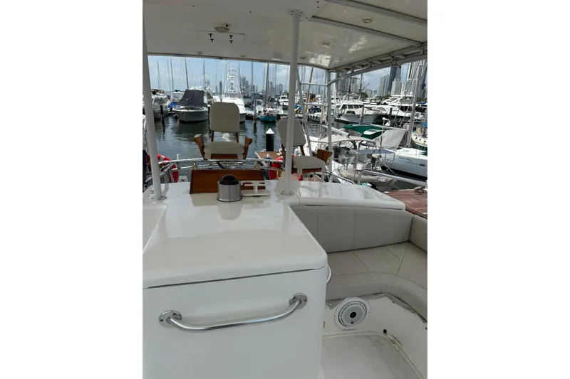  Yacht Photos Pics 1989 Buddy Davis 61 yacht interior with marina view, featuring seating and helm station.