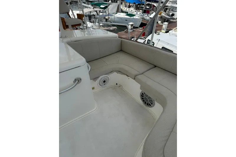  Yacht Photos Pics 1989 Buddy Davis 61 yacht seating area with beige cushions and marina view.