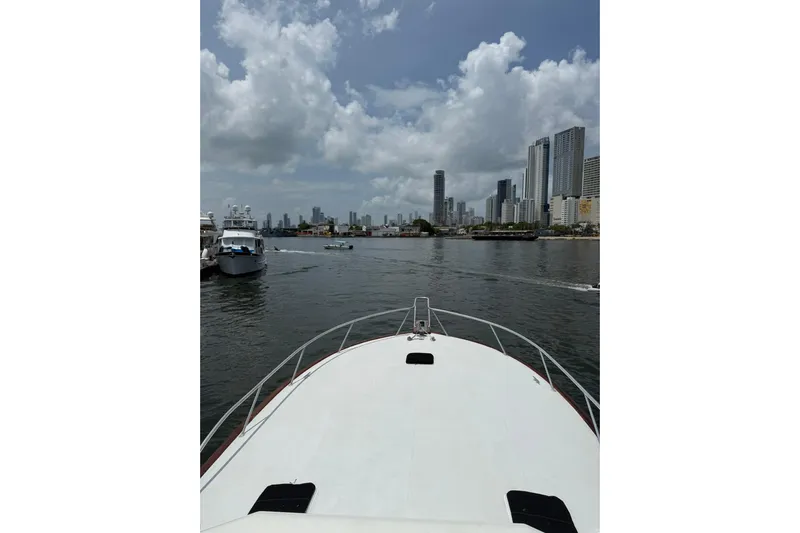  Yacht Photos Pics Bow view from 1989 Buddy Davis 61 yacht, city skyline and boats in the background.