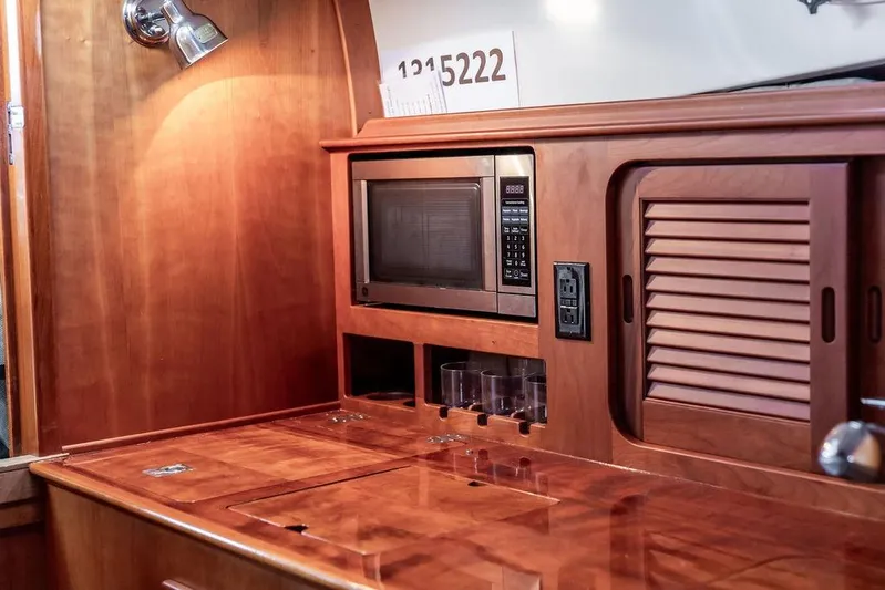 Friendship Yacht Photos Pics Interior of 2010 Hinckley Picnic Boat MKIII with wooden cabinetry and built-in microwave.