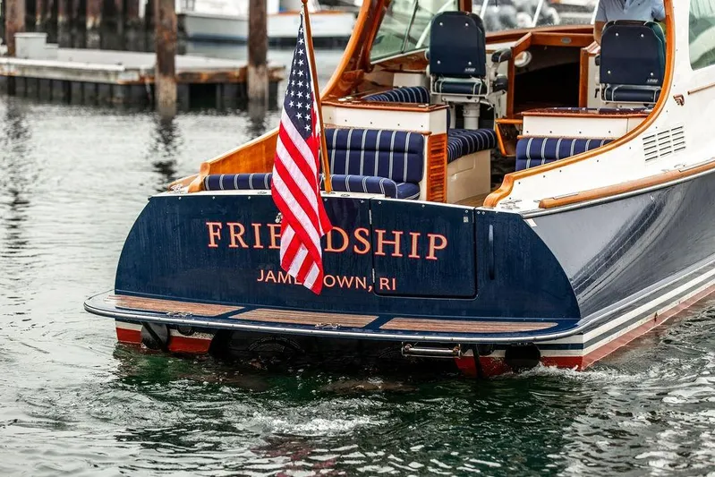 Friendship Yacht Photos Pics Hinckley Picnic Boat MKIII 2010, named "Friendship," with American flag, docked in Jamestown, RI.