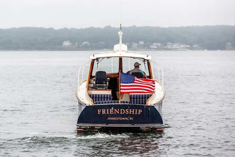 Friendship Yacht Photos Pics Hinckley Picnic Boat MKIII 2010 cruising with American flag, labeled "Friendship," in Jamestown, RI waters.