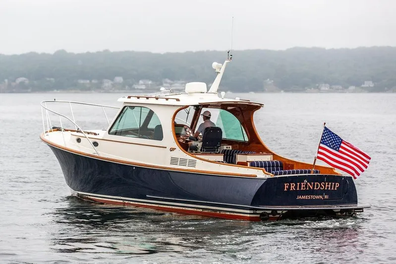 Friendship Yacht Photos Pics Hinckley Picnic Boat MKIII 2010 cruising on water with American flag, named "Friendship".