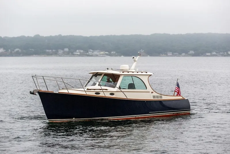 Friendship Yacht Photos Pics Hinckley Picnic Boat MKIII 2010 cruising on calm waters with American flag.