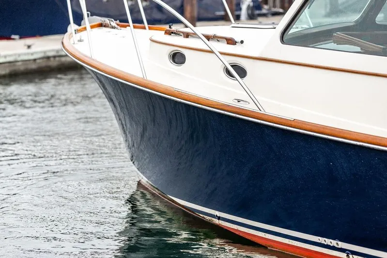 Friendship Yacht Photos Pics 2010 Hinckley Picnic Boat MKIII with sleek navy hull and wooden trim in marina.