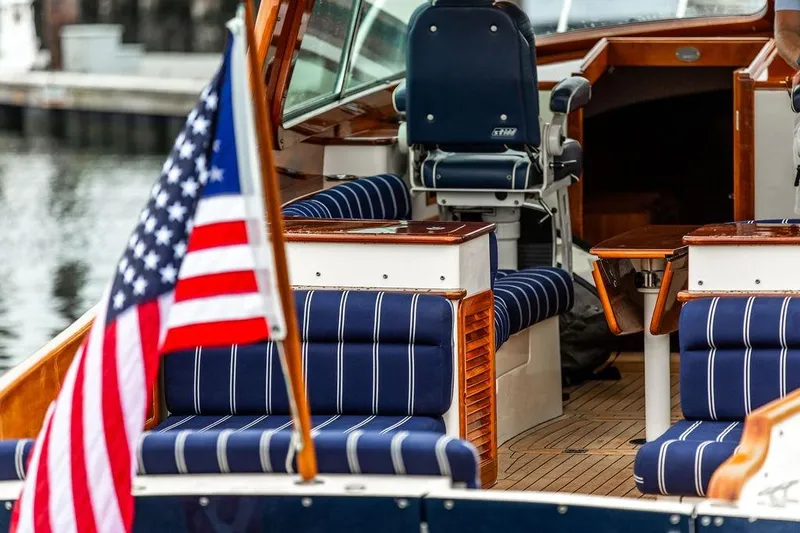 Friendship Yacht Photos Pics Hinckley Picnic Boat MKIII 2010 interior with striped seating and American flag.