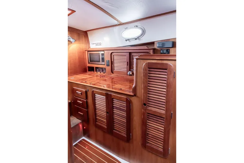Friendship Yacht Photos Pics Hinckley Picnic Boat MKIII 2010 interior with wooden cabinetry and built-in microwave.