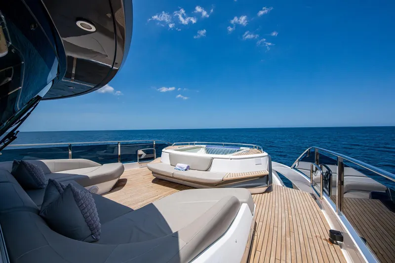Splash Yacht Photos Pics Luxurious 2022 Princess X95 yacht deck with jacuzzi and ocean view.