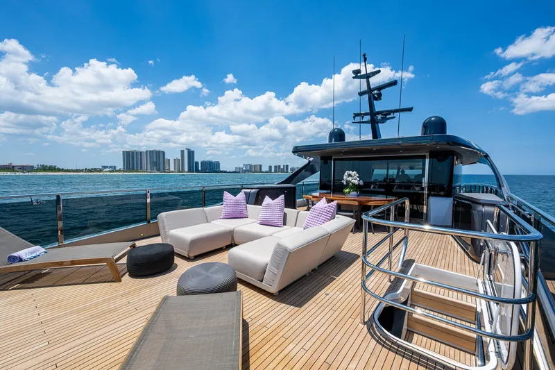 Splash Yacht Photos Pics Luxurious 2022 Princess X95 yacht deck with modern seating, ocean view, and city skyline.
