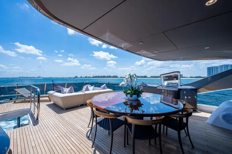 Splash Yacht Photos Pics Luxurious 2022 Princess X95 yacht deck with dining area, ocean view, and modern amenities.