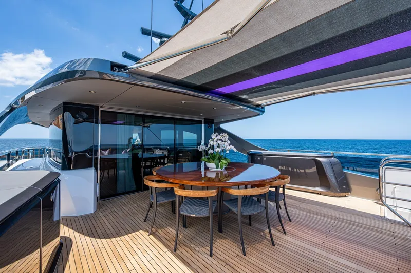 Splash Yacht Photos Pics Luxurious 2022 Princess X95 yacht deck with elegant dining area and ocean view.