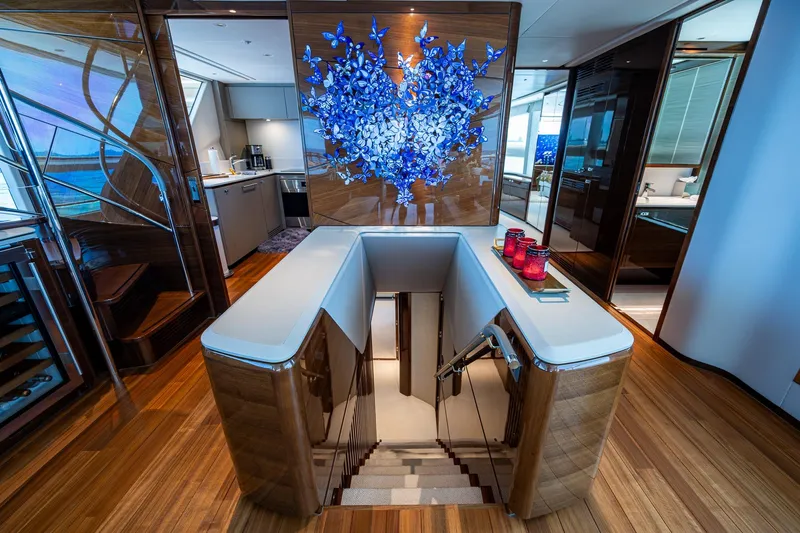 Splash Yacht Photos Pics Luxurious interior of 2022 Princess X95 yacht with elegant staircase and modern decor.