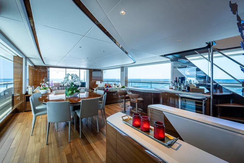 Splash Yacht Photos Pics Luxurious interior of 2022 Princess X95 yacht with elegant dining area and ocean view.