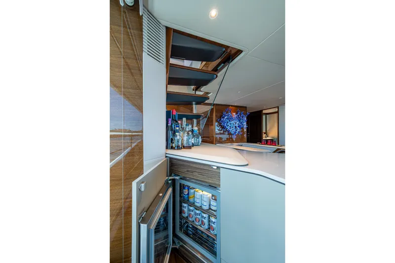 Splash Yacht Photos Pics Luxurious 2022 Princess X95 yacht interior with modern bar and open fridge.