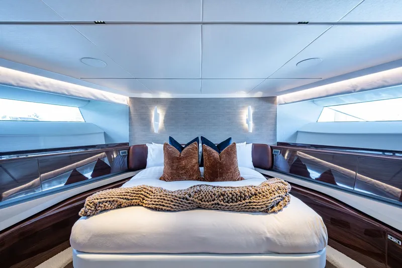 Splash Yacht Photos Pics Luxurious bedroom interior of 2022 Princess X95 yacht with elegant decor and plush bedding.