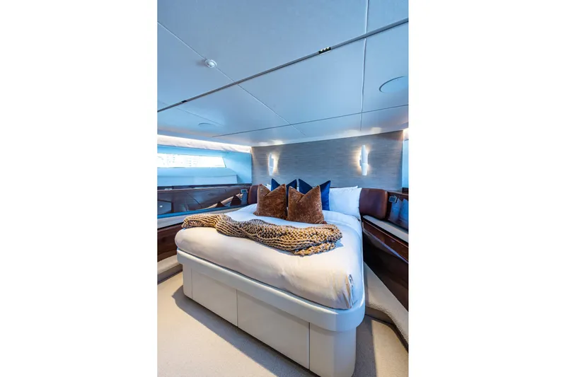 Splash Yacht Photos Pics Luxurious bedroom interior on 2022 Princess X95 yacht, featuring elegant bedding and modern lighting.