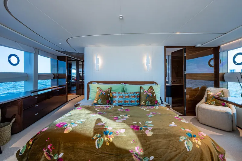 Splash Yacht Photos Pics Luxurious 2022 Princess X95 yacht bedroom with ocean view and elegant floral decor.