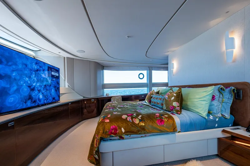 Splash Yacht Photos Pics Luxurious bedroom interior of 2022 Princess X95 yacht with ocean view and modern decor.