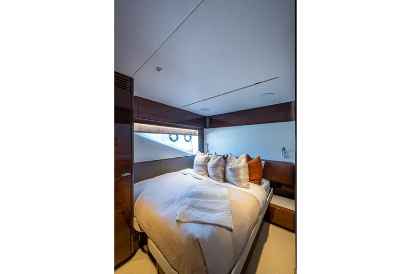 Splash Yacht Photos Pics Luxurious bedroom interior of 2022 Princess X95 yacht with elegant bedding and modern design.