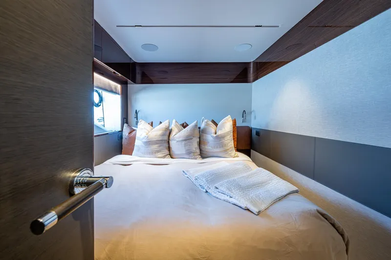 Splash Yacht Photos Pics Luxurious bedroom interior on 2022 Princess X95 yacht, featuring elegant bedding and modern design.