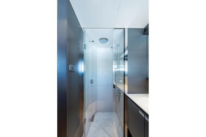 Splash Yacht Photos Pics Luxurious bathroom interior on 2022 Princess X95 yacht, featuring sleek glass shower enclosure.