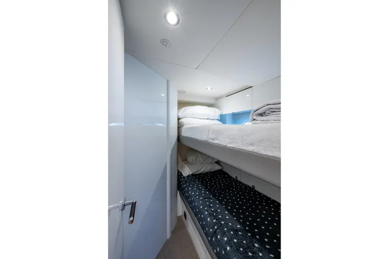 Splash Yacht Photos Pics Interior of 2022 Princess X95 yacht featuring cozy bunk beds and modern lighting.