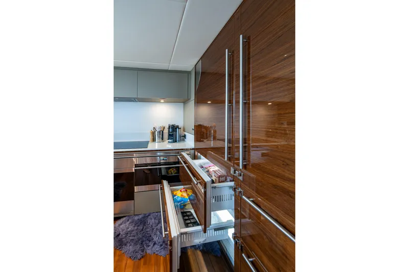 Splash Yacht Photos Pics Luxurious kitchen interior of 2022 Princess X95 yacht with sleek cabinetry and modern appliances.