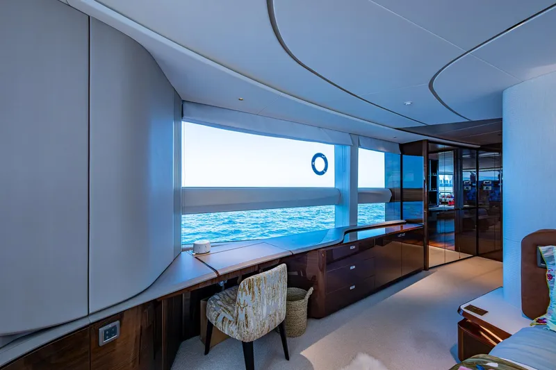 Splash Yacht Photos Pics Luxurious interior of 2022 Princess X95 yacht with ocean view through large windows.