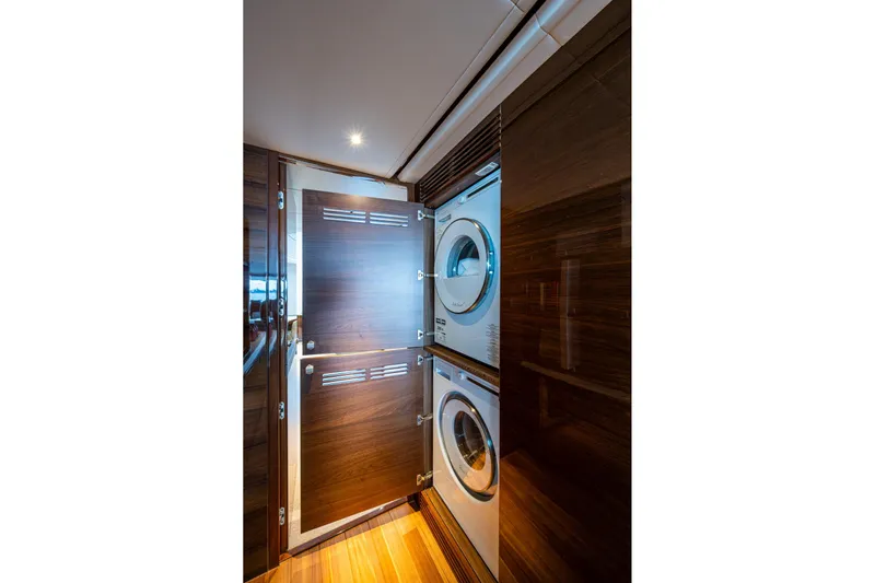 Splash Yacht Photos Pics Laundry area with stacked washer and dryer on 2022 Princess X95 yacht.