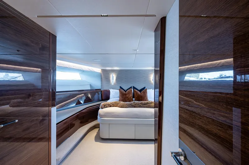 Splash Yacht Photos Pics Luxurious bedroom interior of 2022 Princess X95 yacht with elegant wood finishes.