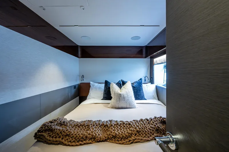 Splash Yacht Photos Pics Luxurious bedroom interior of 2022 Princess X95 yacht with cozy bedding and modern design.