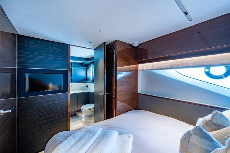 Splash Yacht Photos Pics Luxurious bedroom interior of 2022 Princess X95 yacht with modern design and ensuite bathroom.