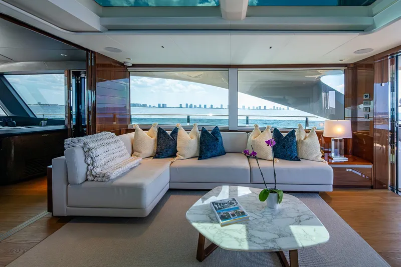 Splash Yacht Photos Pics Luxurious 2022 Princess X95 yacht interior with elegant seating, marble table, and ocean view.