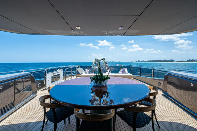 Splash Yacht Photos Pics Luxurious 2022 Princess X95 yacht deck with ocean view and elegant dining setup.