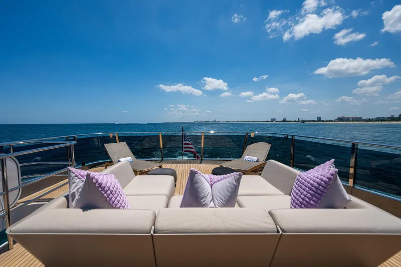 Splash Yacht Photos Pics Luxurious 2022 Princess X95 yacht deck with plush seating, ocean view, and clear blue sky.
