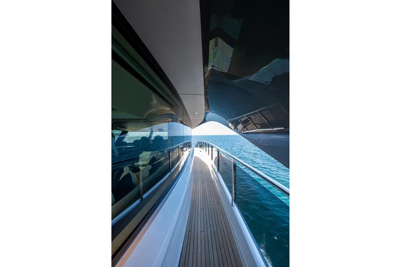 Splash Yacht Photos Pics Side deck view of 2022 Princess X95 yacht cruising on open sea.