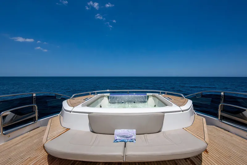 Splash Yacht Photos Pics Luxurious 2022 Princess X95 yacht deck with jacuzzi and ocean view.