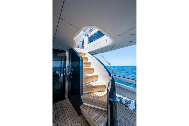 Splash Yacht Photos Pics Elegant staircase on 2022 Princess X95 yacht with ocean view.
