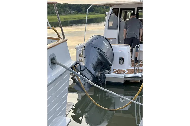 Anima Gemella Yacht Photos Pics 2023 Ranger Tugs R-27 with Yamaha outboard motor docked on calm water.