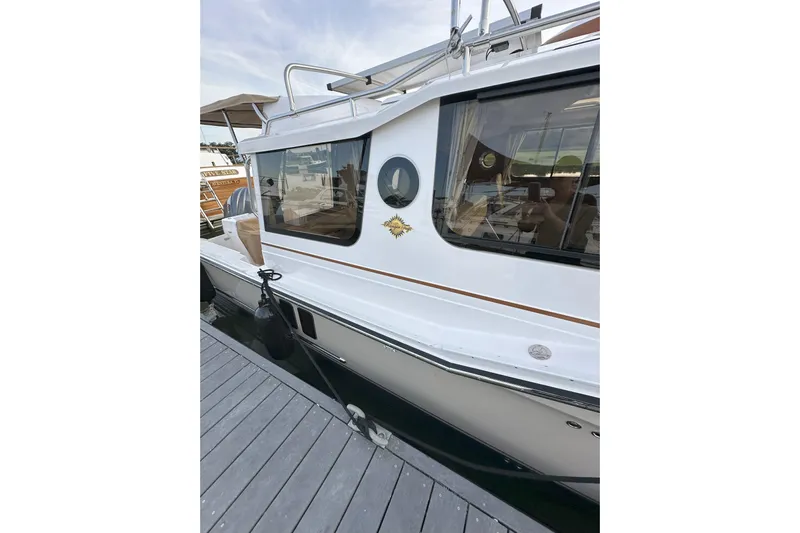 Anima Gemella Yacht Photos Pics 2023 Ranger Tugs R-27 boat docked, showcasing sleek design and modern features.