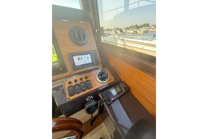 Anima Gemella Yacht Photos Pics 2023 Ranger Tugs R-27 helm with navigation controls and marina view.
