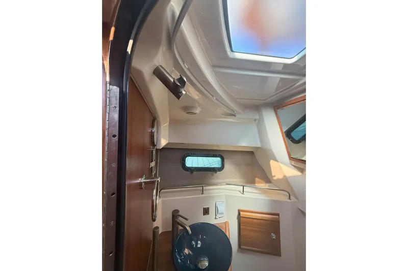 Anima Gemella Yacht Photos Pics Interior of 2023 Ranger Tugs R-27 boat, featuring a compact cabin with a skylight.
