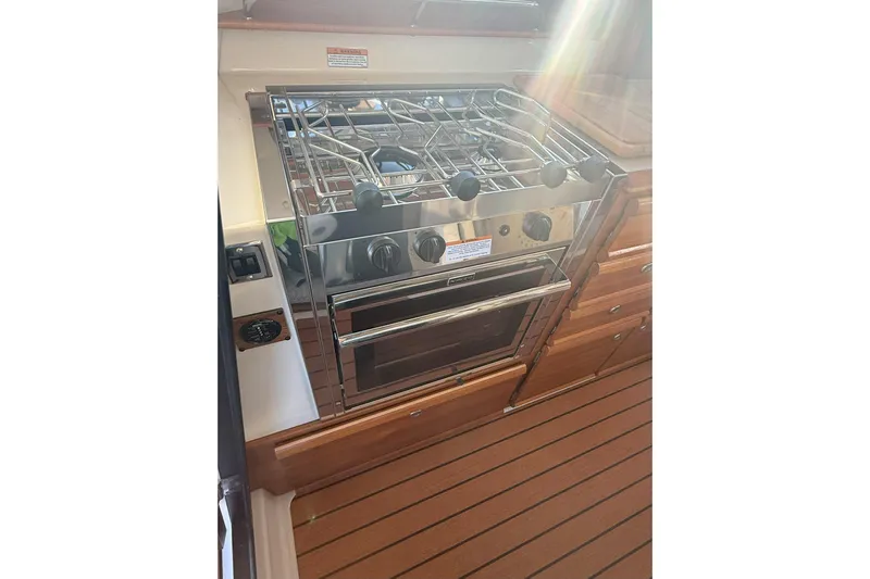 Anima Gemella Yacht Photos Pics 2023 Ranger Tugs R-27 boat kitchen with stainless steel stove and oven.